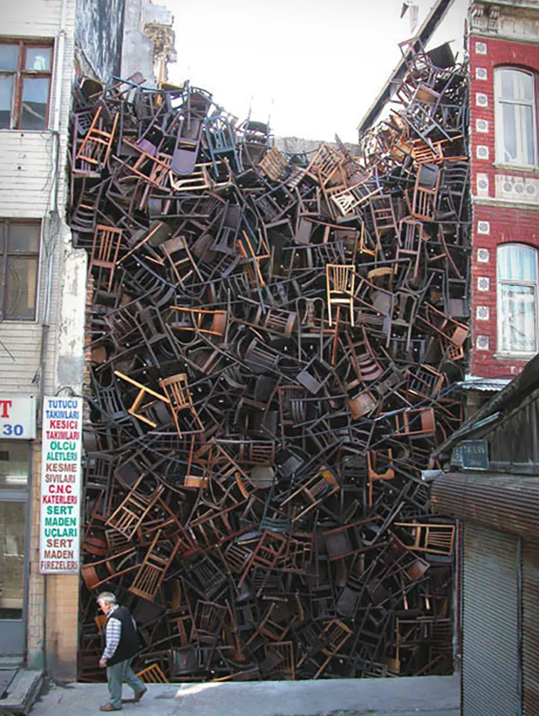 1550 Chairs Stacked Between Two City Buildings