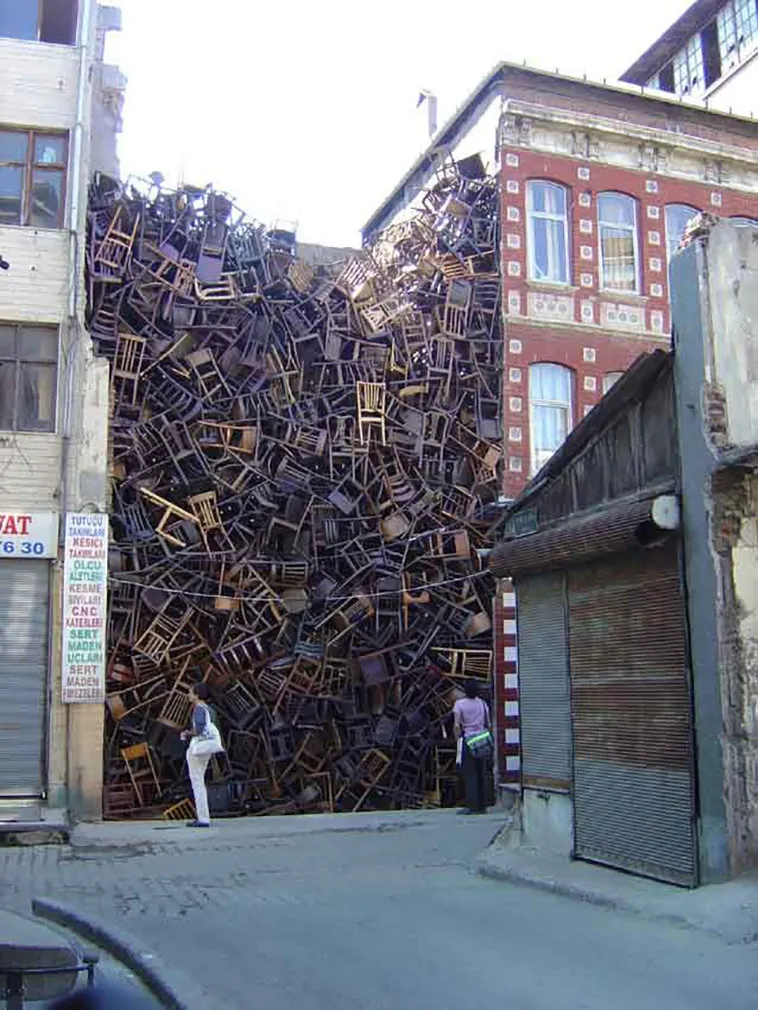 1550 Chairs Stacked Between Two City Buildings 3