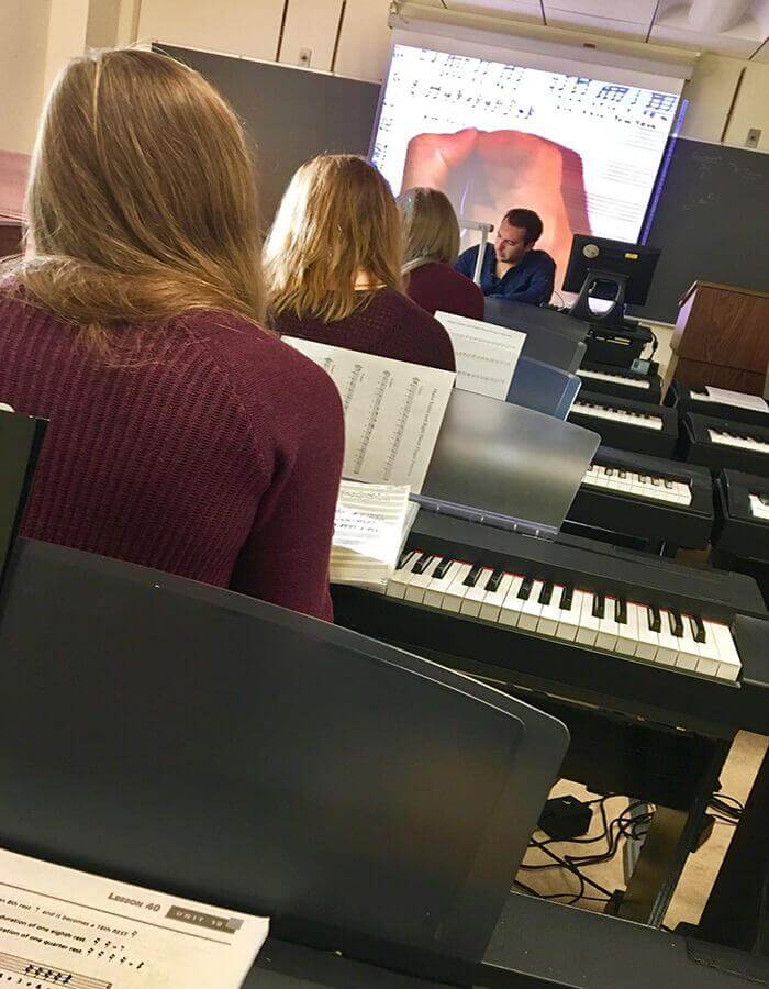 Three Girls In The Same Row, Wearing The Same Color Sweater, With The Same Color Hair