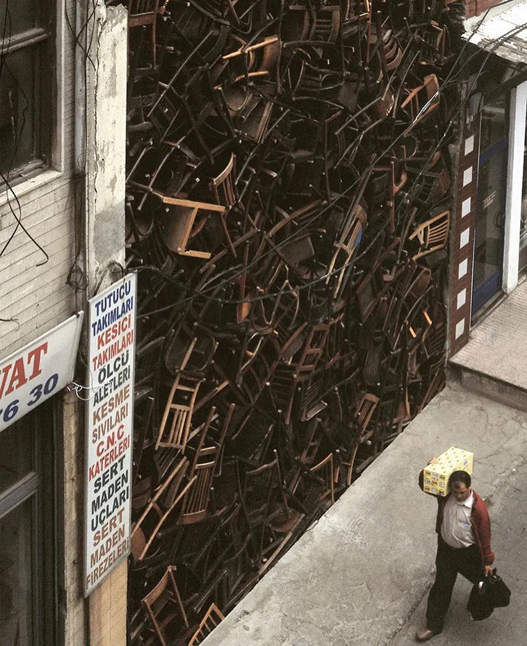 1550 Chairs Stacked Between Two City Buildings 4